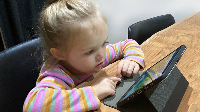 preschool girl doing an ABC Reading Eggs learning activity on iPad.
