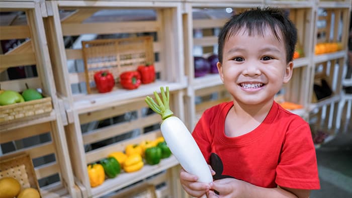 preschool child plays shop for maths activity