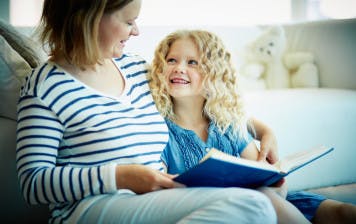 child-reads-social-story-with-mother